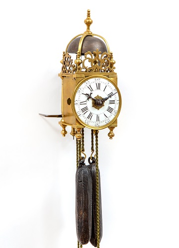 A miniature French brass lantern wall clock with striking and alarm, circa 1750.